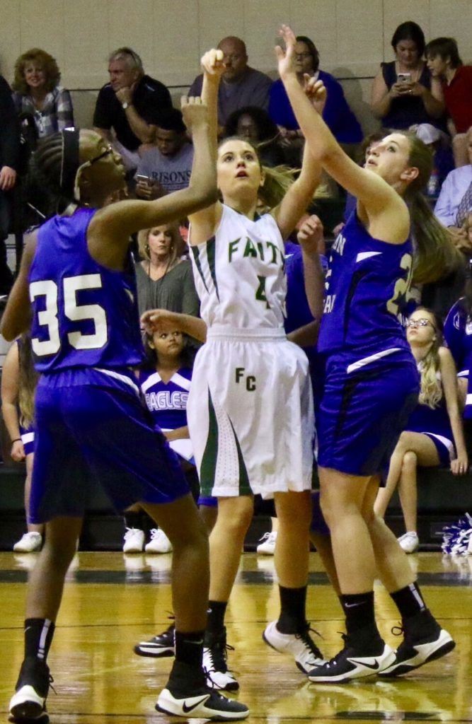 Faith's Shelley Ann Phillips (4) stays focused on the goal as Jefferson Christian's Morgan Wormley (35) and Taylor Mann apply pressure. (Photo by Laura A. Phillips)