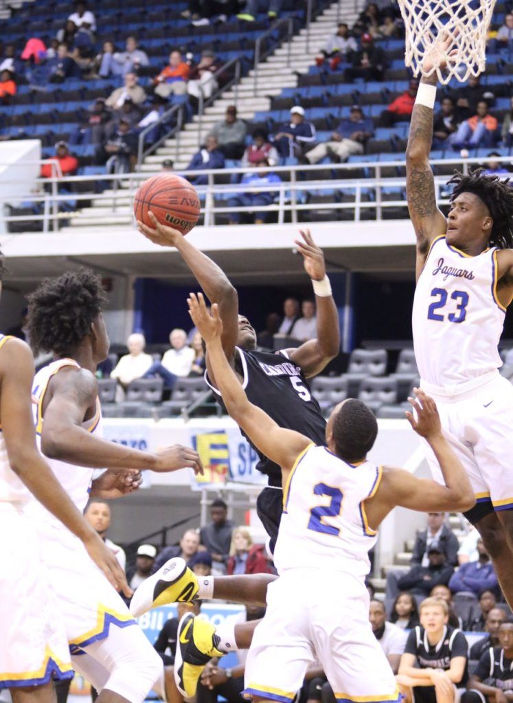 Alabama signee John Petty (23) goes high to disrupt Sacred Heart guard D.J. Heath's shot in Monday's game. Below, Petty goes stride-for-stride with Dionte Wood. (Photos by Kristen Stringer/Krisp Pics Photography)