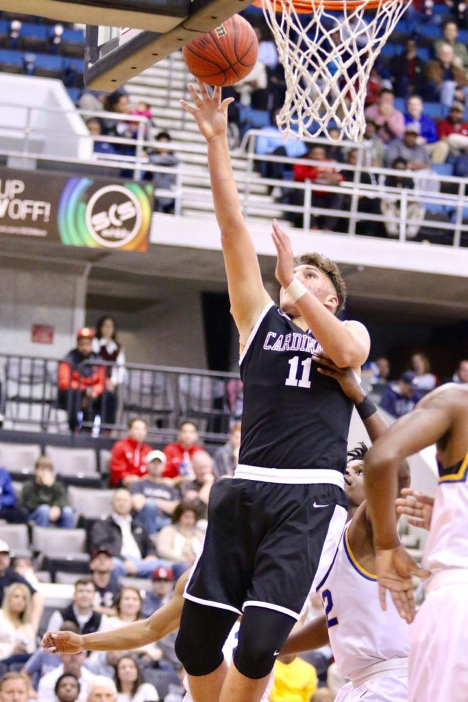 Sacred Heart newcomer Dakota Myers lays in his only basket of the game in his return to his old stomping grounds. Myers joined the Cardinals from Grissom. (Photo by Kristen Stringer/KrispPics Photography) 