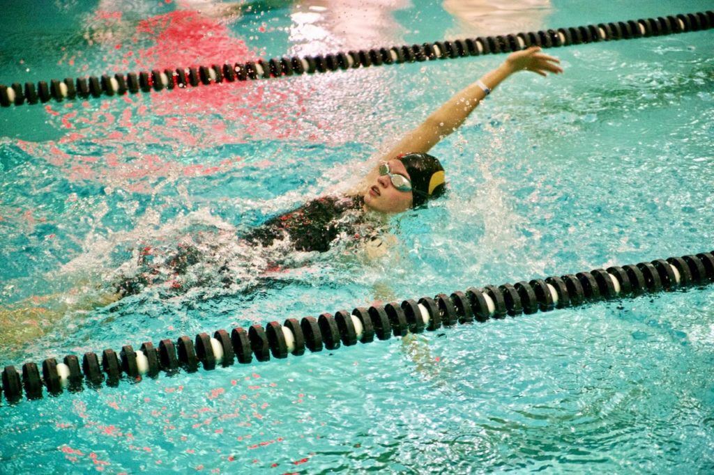 Heather Wright of girls team champion Oxford cuts through the water in her 100 backstroke race. (Photo by B.J. Franklin/GungHo Photos)