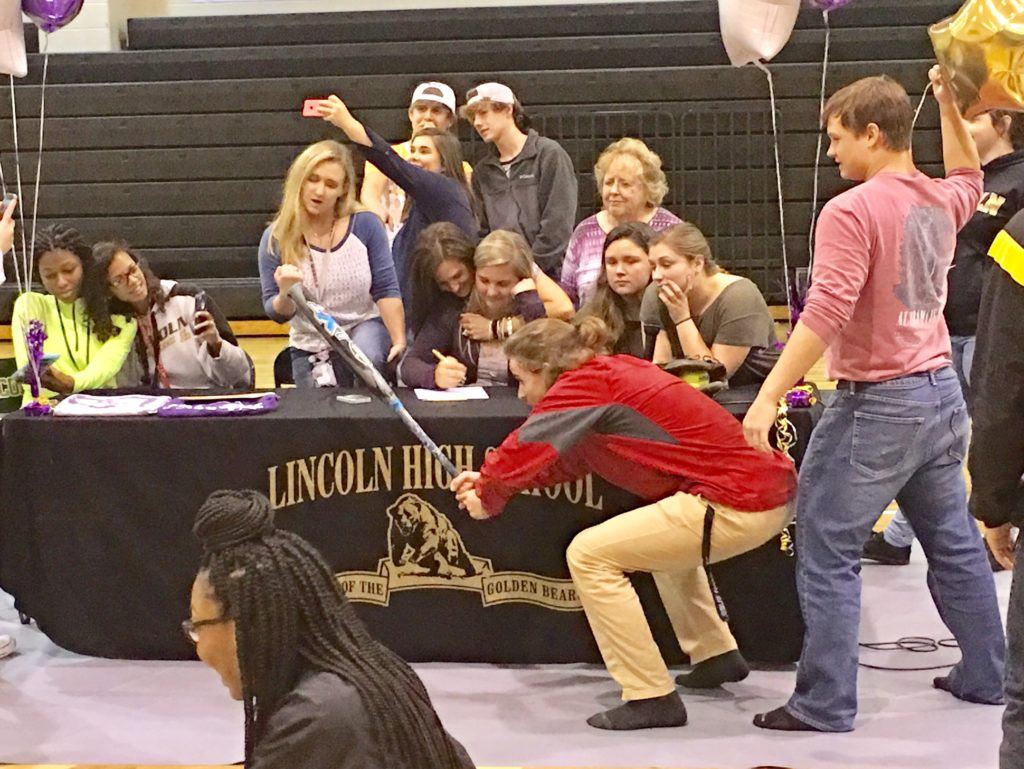 Carlee Mullinax (seated center) and her friends do a Mannequin Challenge after the Lincoln third baseman signed scholarship papers to play softball at Montevallo.