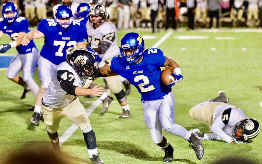 Piedmont running back Lee Stanley leaves one Colbert County defender in the dust and tries to get around another in last week's playoff game. (Photos by B.J. Franklin/GungHo Photos)