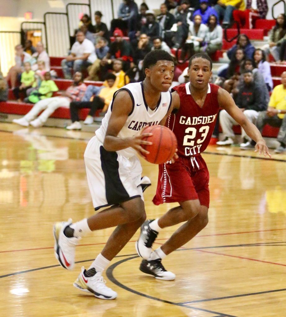 Khalil Watkins (L) drives past Gadsden City's Dee Pearson in the first half Thursday night. Watkins drew the start so he could gain confidence playing with the Sacred Heart veterans and scored 12 points in the victory. (Photo by Kristen Stringer/KrispPics Photography) 