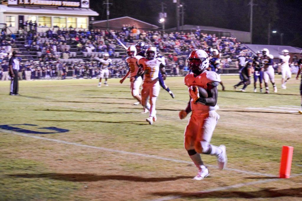 Randolph County's Trent Lane steps into the end zone with one of his two touchdowns Friday night. On the cover, Tre Terrell intercepts a fourth-quarter pass squashes any chances of a J.B. Pennington rally. (Photos Jeremy Wortham/Tiger Den Photography)