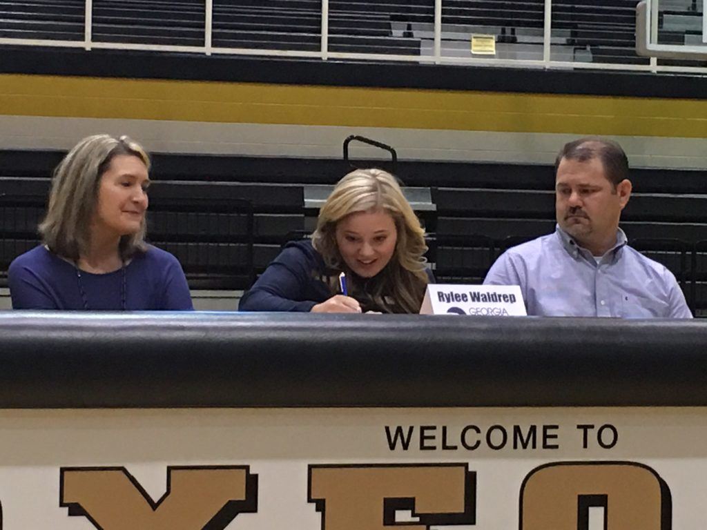 Oxford pitcher Rylee Waldrep, flanked by her parents, signs with Georgia Southern Wednesday.