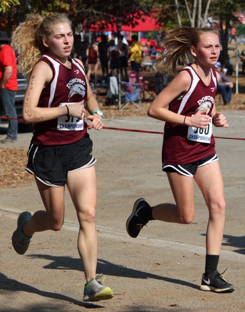 Donoho teammates Libby Davis and Savannah Frickey run together and finish together in the top 40 of Saturday's 1A-2A girls race. (Photo by Laura A. Phillips)