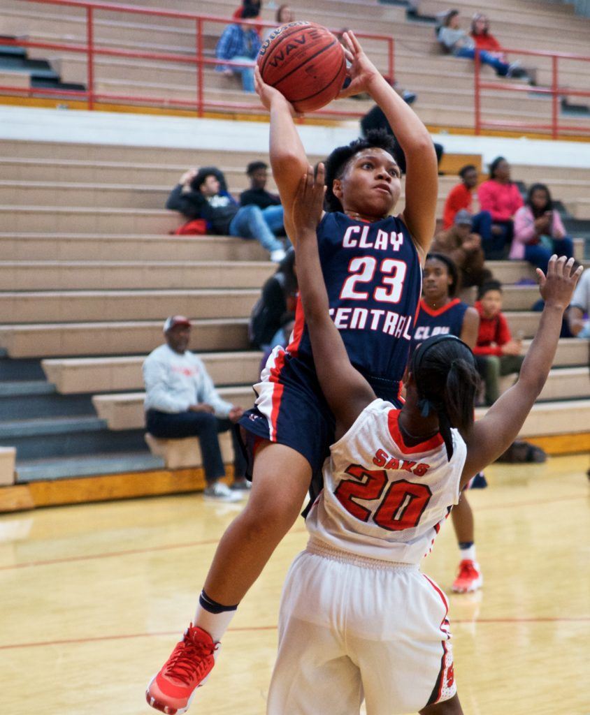 Clay Central's Ahnyah Denny (23) goes hard to the basket against Saks' Miracle Dennard. (Photo by B.J. Franklin/GungHo Photos)