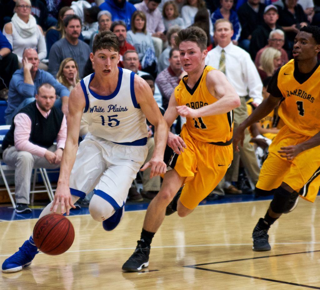 Michael McGuirk (15) drives to the basket against Cherokee County's Colin Edwards. On the cover, Macy Carr gets aggressive on defense. (Photos by B.J. Franklin/GungHo Photos)