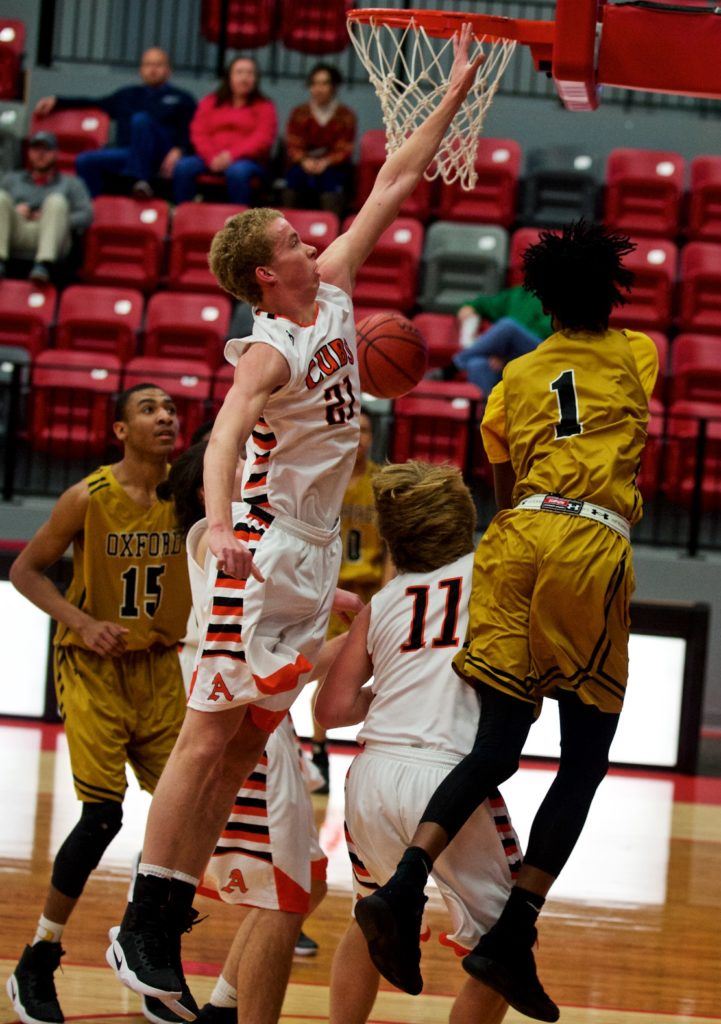 Alexandria's Dalton Dodd (21) jumps to disrupt Markise Davis' drive on the baseline. Dodd later left the game with an ankle injury. (Photo by B.J. Franklin/GungHo Photos)