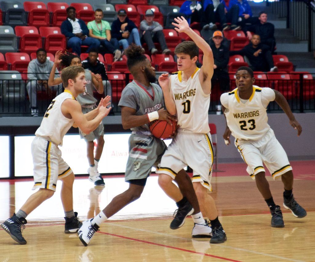 Cherokee County's Kyle Burgess (10) and Jacob Graves (2) close in on Anniston guard Marrio Dobbins. On the cover, DeMarcus Barrington launches one of his seven 3-pointers that helped the Warriors win in overtime. (Photos by B.J. Franklin/GungHo Photos)