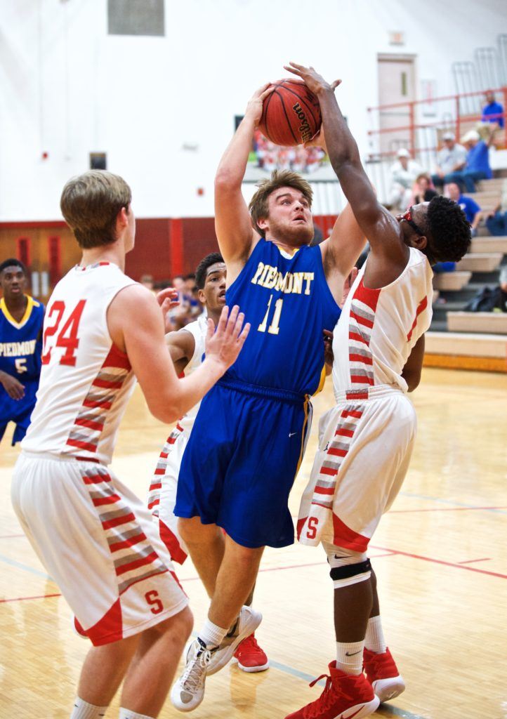 Piedmont's Taylor Hayes (11) drives between Saks' Chuck Taylor (R) and Jalen Borders. (Photo by B.J. Franklin/GungHo Photos)