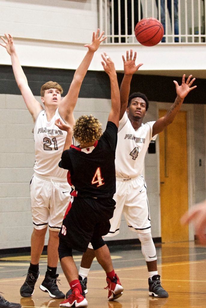 Wellborn's Austin Cooper (21) and Jordan Montgomery (right) don't give Weaver's Robert Gaines much room to work. (Photo by B.J. Franklin/GungHo Photos)