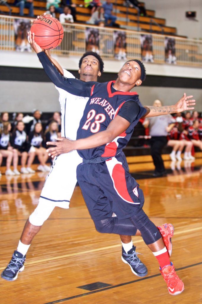 Wellborn's Jordan Montgomery looks like he has all ball as he denies Weaver's Shamar Spinks (23). (Photo by B.J. Franklin/GungHo Photos)