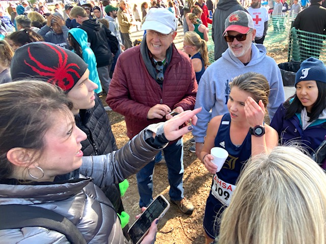 Jacksonville’s Olivia King talks with family after finishing third in the state cross country meet as a sophomore in 2019. It was after this race she spoke bravely about overcoming an eating disorder that consumed her life.