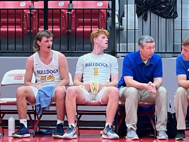 Alex Odam (1) sits on the Piedmont bench in the Calhoun County Tournament inside Jax State’s Pete Mathews Coliseum and cranes his neck to see the action on the other end of the floor.