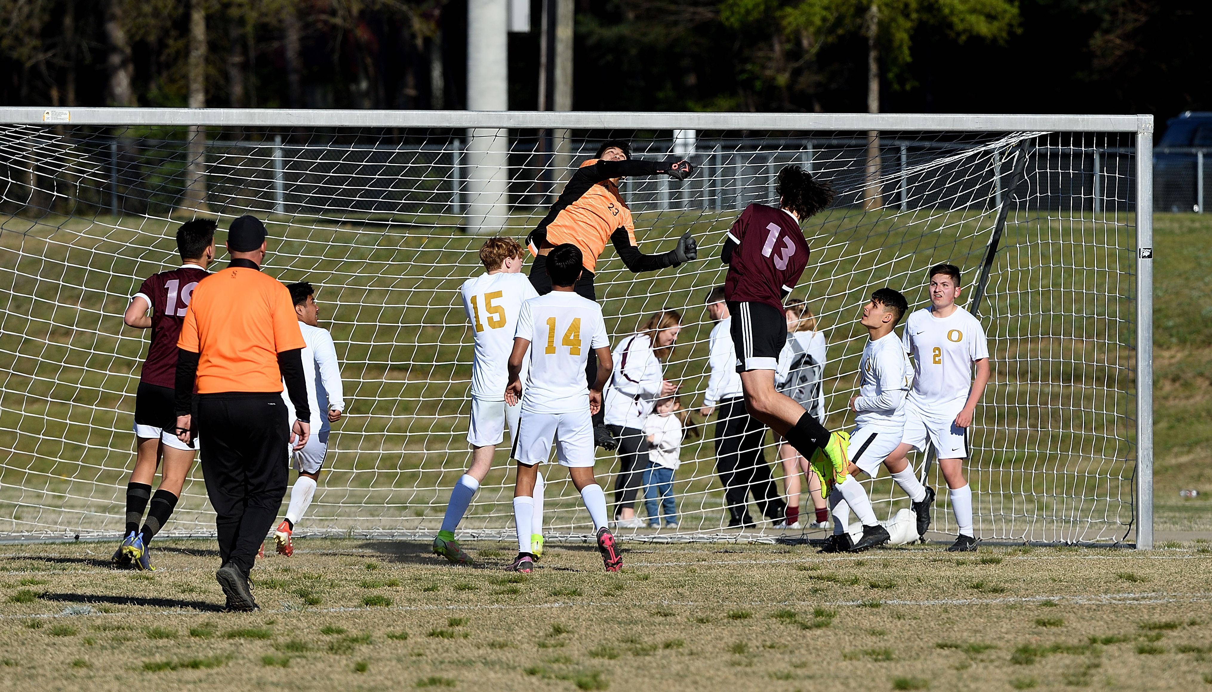 Oxford keeper Carlos Martinez goes high to turn back a shot from Donoho’s Logan Melton (13) in Saturday’s county title game. (Photo by B.J. Franklin/GungHo Photos)