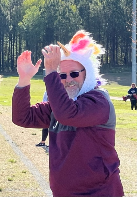 Donoho girls soccer coach Jay Jenkins celebrates his team’s county title in his new unicorn hat.