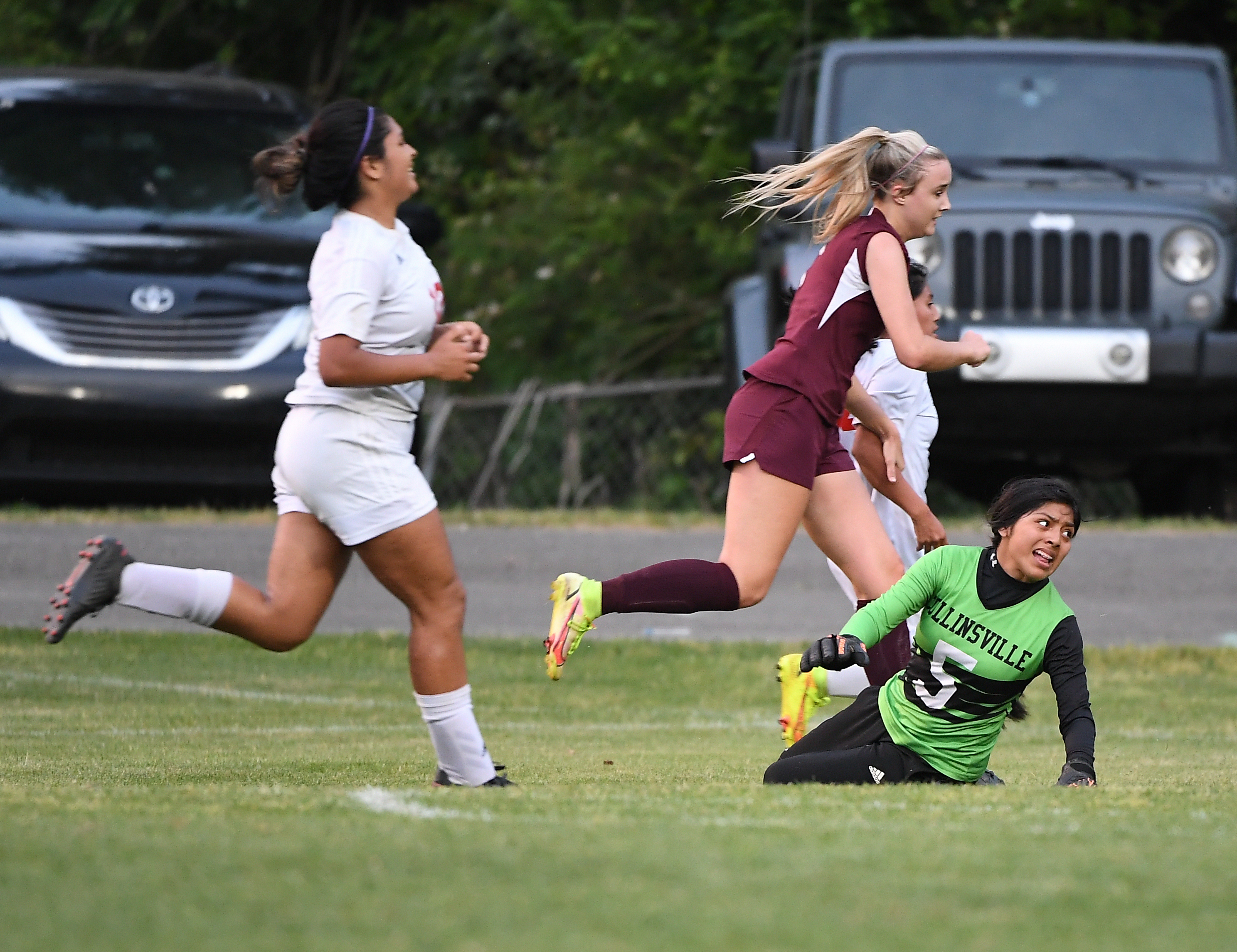 Donoho’s Erin Turley runs past Collinsville keeper Catalina Augustin after scoring the Lady Falcons’ second goal of the game. (Photo by B.J. Franklin) On the cover, Donoho’s Drew Williamson (7) leads the celebration after the Falcons beat Susan Moore on a golden goal.
