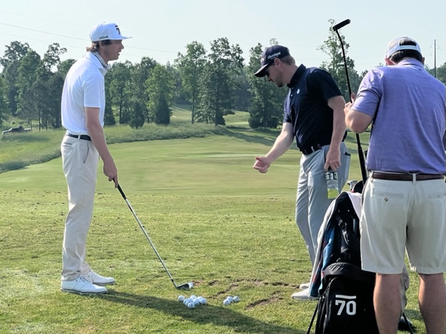 Willy Wilcox (L) works with swing coach Jammie Lett, the director of golf at Oxford’s Cider Ridge Golf Club, on the range Thursday prior to playing in the U.S. Open qualifier at Silver Lakes. Wilcox shot 66 to advance to the next stage.