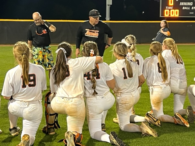 Alexandria softball coach Brian Hess addresses his team after it clinched a spot in the Class 5A state championship game.