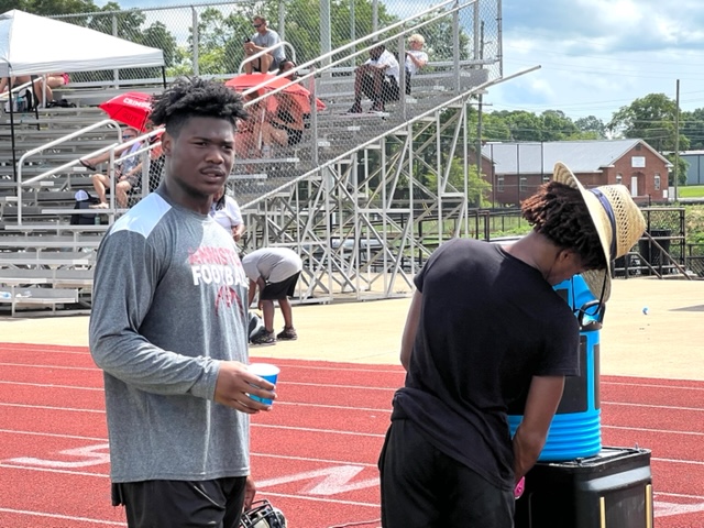 Anniston quarterback and South Carolina commitment Kam Sandlin (L) takes a much-needed break on a hot day.