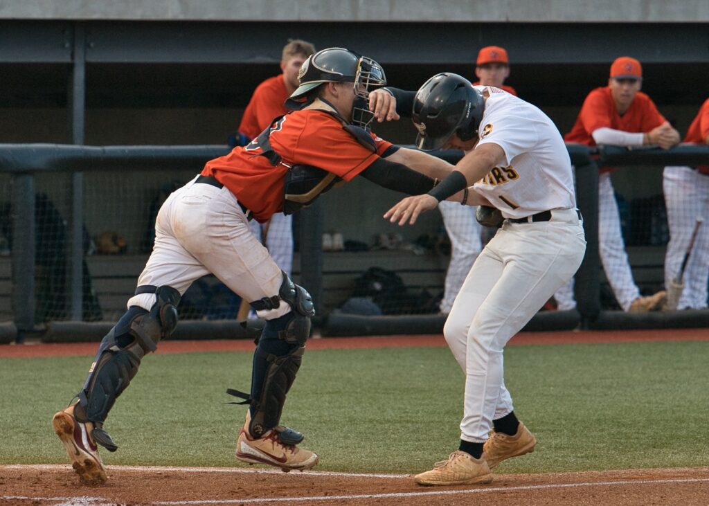 Gwinnett Astros catcher Cohen Wilbanks (L) puts the tag on Choccolocco’ Brant Deerman to deny the Monsters another first-inning run Saturday night. On the cover, Monsters manager Steve Gillispie make the call to his bullpen in the fifth inning. (Photos by B.J. Franklin)
