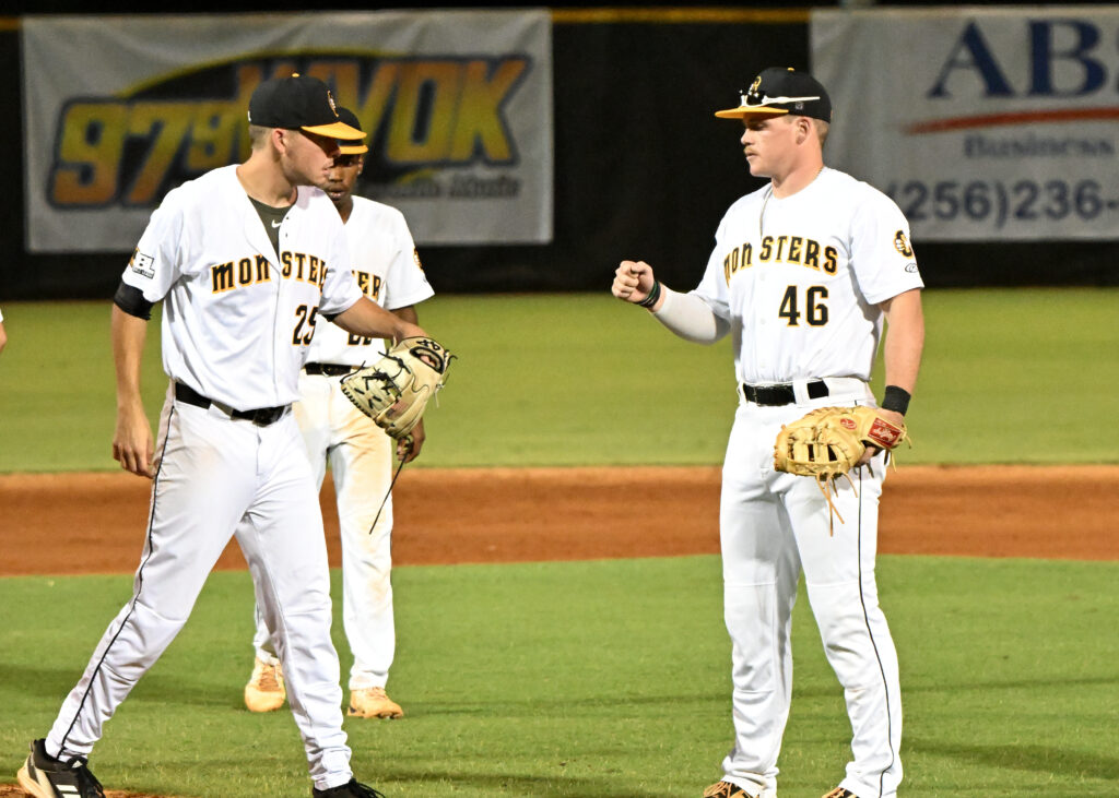 Austin Goode (25) gets a fist bump from first baseman Sean Smith after the Monsters’ right-hander is lifted in the sixth in order to pitch later in the week. (Photos by B.J. Franklin)
