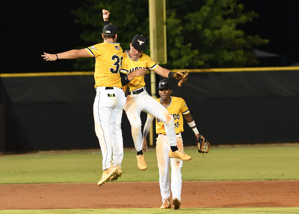 Choccolocco second baseman Brant Deerman (C) celebrates with Jackson Sweatt after the Monsters finished off the Gwinnett Astros for their first win at home this past Sunbelt Baseball League season. Deerman was named to the All-SBL Team Tuesday. (Photo by B.J. Franklin)