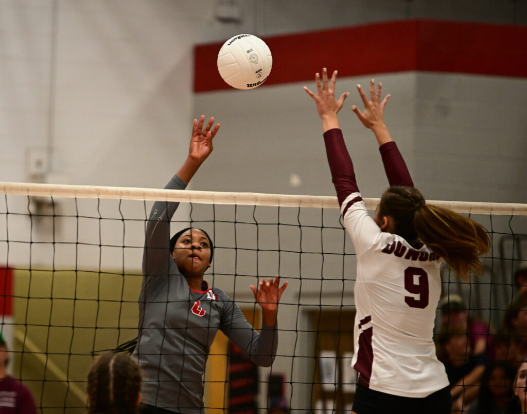 Donoho’s Estella Connell (9) goes up to block Ohatchee’s Jorda Crook. Connell made the block and the top-ranked Lady Falcons went on to beat their hosts. (Photo by B.J. Franklin)