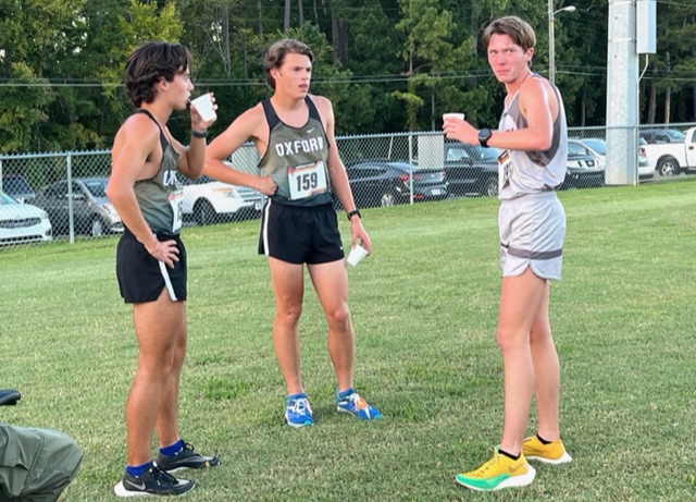 Oxford’s Noah George and Evan Somers (left, center) cool down after Tuesday’s Bulldog Twilight boys race with Southside’s Jackson Griggs. On the cover, Oxford race winners George and Katie Keur.