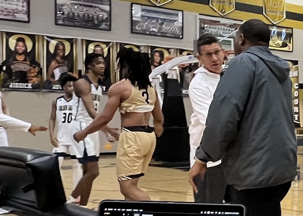B.B. Comer coach Marcus Herbert (R) greets his coach and mentor, Jacksonville assistant Daryl Hamby, after the Golden Eagles handed the Tigers a 95-59 loss in Herbert’s return as a head coach.