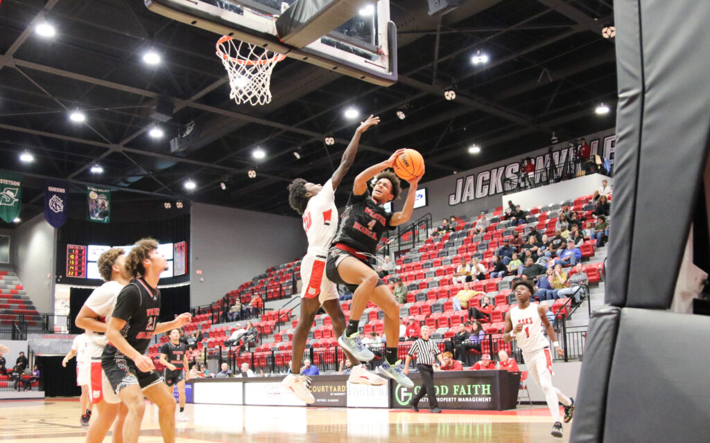 Weaver’s KeShawn Allen shoots a contested shot against Saks during Monday’s Calhoun County tournament action in Pete Mathews Coliseum. (Photo by Greg Warren)