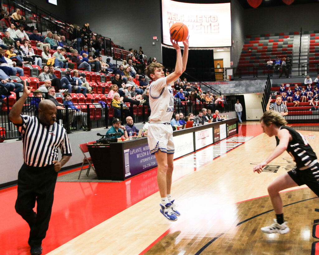 White Plains’ Jacob Wheeler launches a 3 against Jacksonville Christian during Monday’s Calhoun County tournament action in Pete Mathews Coliseum (Photo by Greg Warren)