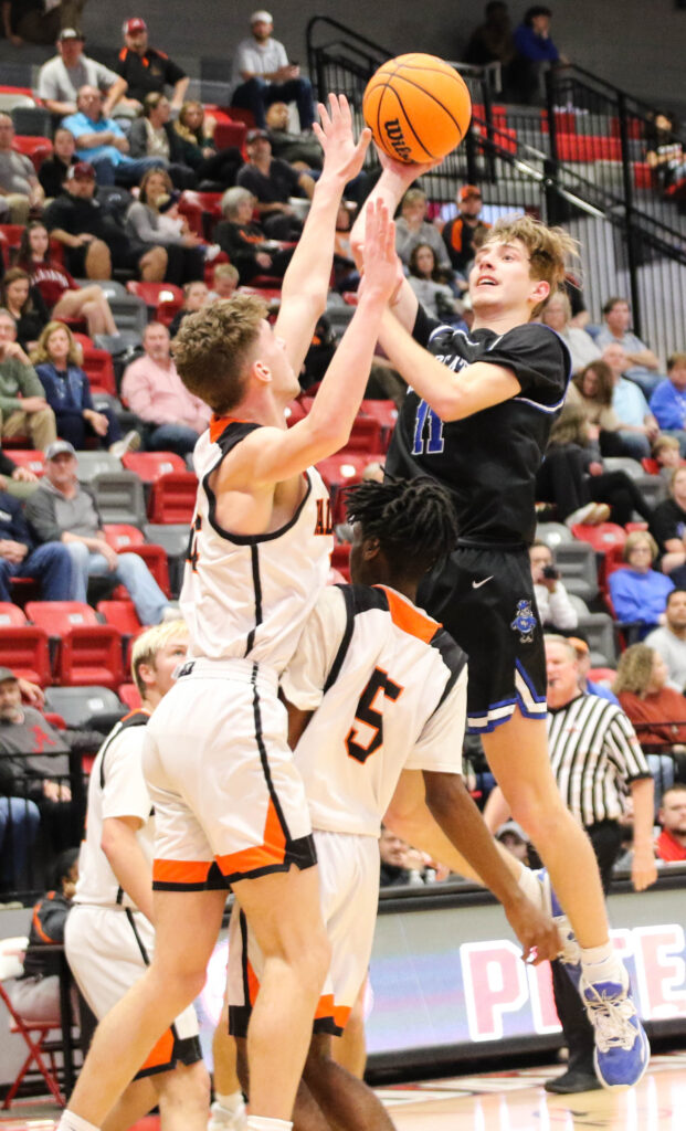 White Plains’ Josh Wheeler (11) tries to score while Alexandria’s Kory Cargal defends Wednesday in Pete Mathews Coliseum. (Photo by Greg Warren)