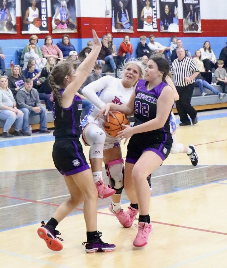 Pleasant Valley’s Macey Roper (44) is caught between Ranburne’s Aubree Anglin (L) and Sadie Phillips. On the cover, Briley Merrill drives to the basket for a layup. (Photo by Krista Larkin)