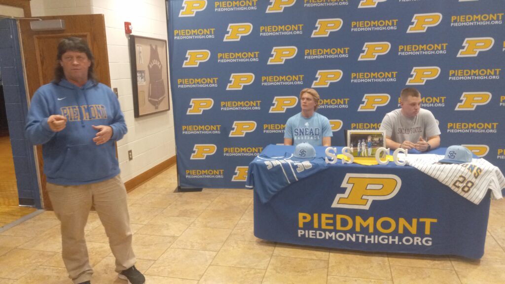Piedmont athletics director Steve Smith talks during Thursday’s ceremony to mark the signings of Bulldog standouts Max Hanson (left) and Jack Hayes to play baseball for Snead State Community College. (Photo by Joe Medley)