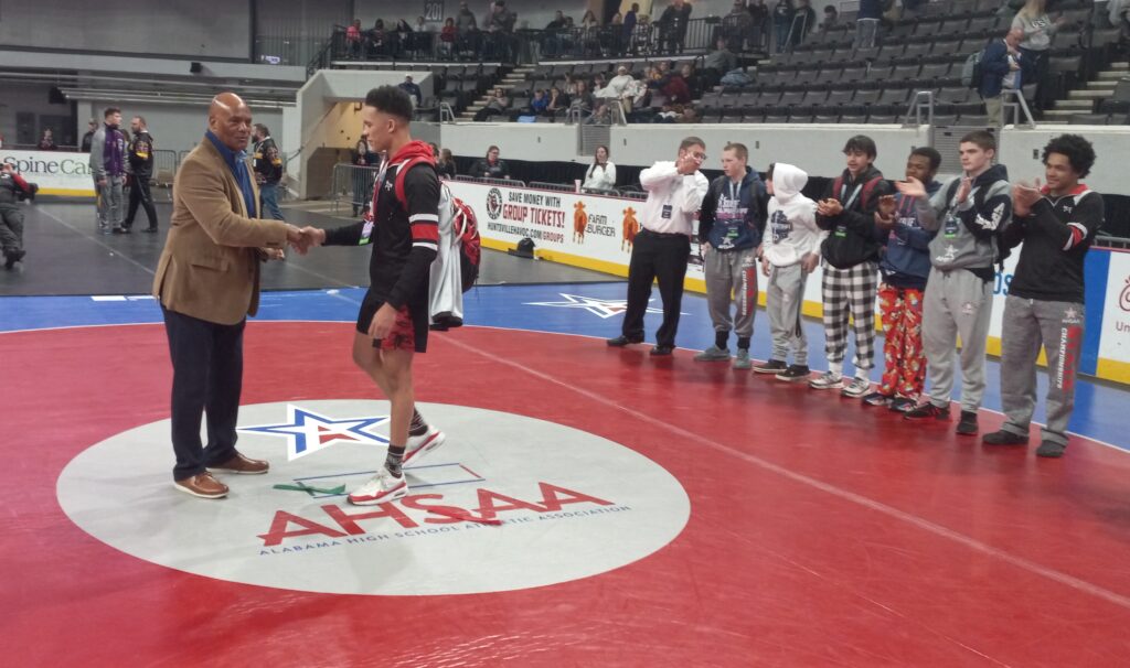 AHSAA executive director Alvin Briggs presents Weaver’s J.D.Johannson with the award for being the 2023 Class 1A-4A most outstanding wrestler Saturday in Huntsville. (Photo by Joe Medley)