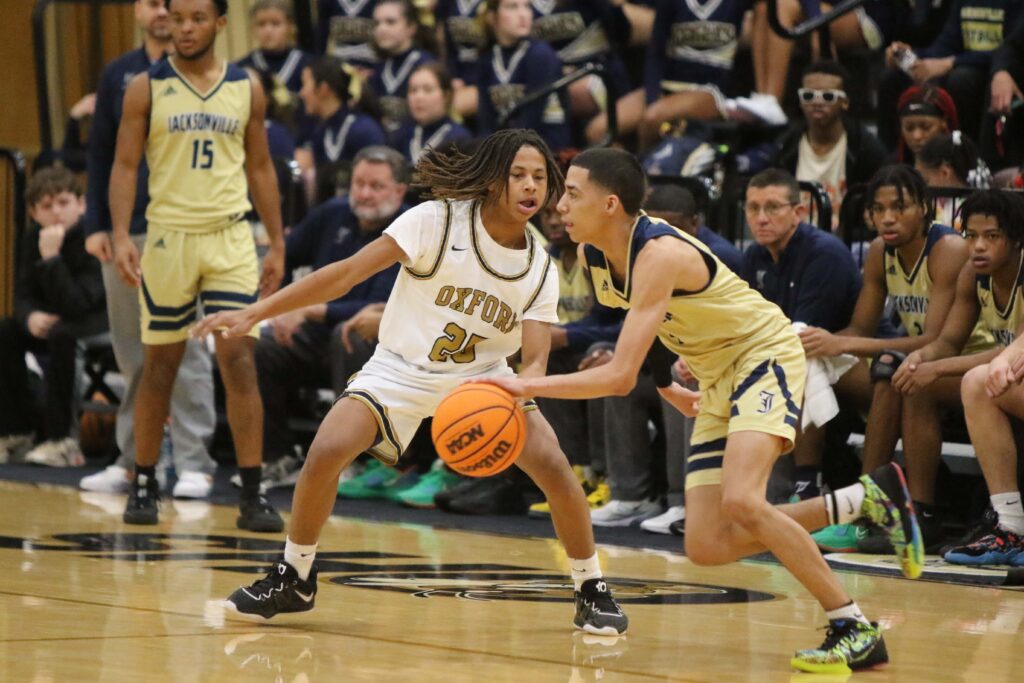 Jacksonville’s Devin Barksdale looks to drive around Oxford’s Elijah Malone (25) during Friday night’s rematch of the Calhoun County Tournament finals. 