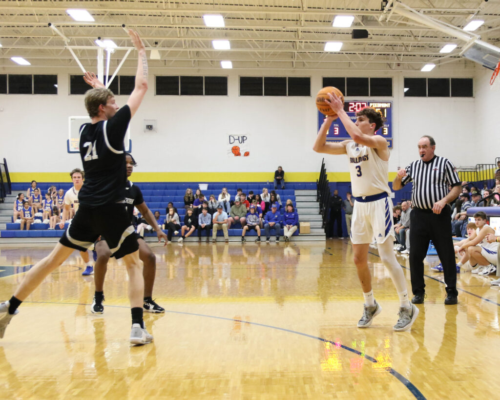 Piedmont’s Rollie Pinto shoots as Wellborn’s Ethan Tidwell defends during their Class 3A, Area 11 tournament game Tuesday at Piedmont. The Bulldogs won 80-44. (Photo by Greg Warren).