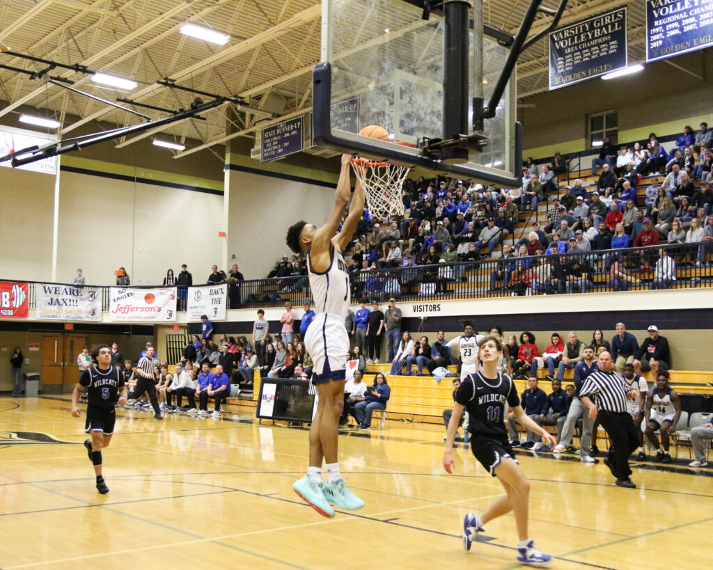 Jacksonville senior John Broom dunks in the second half of Saturday’s Class 4A, Area 10 championship at Jacksonville. (Photo by Greg Warren)