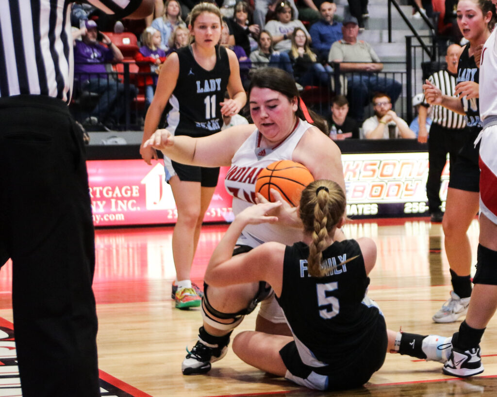 Ohatchee’s Alyssa Davis battles Plainview’s Saydi Jackson for a held ball during their Northeast Regional semifinal Monday in Pete Mathews Coliseum. (Photo by Greg Warren)