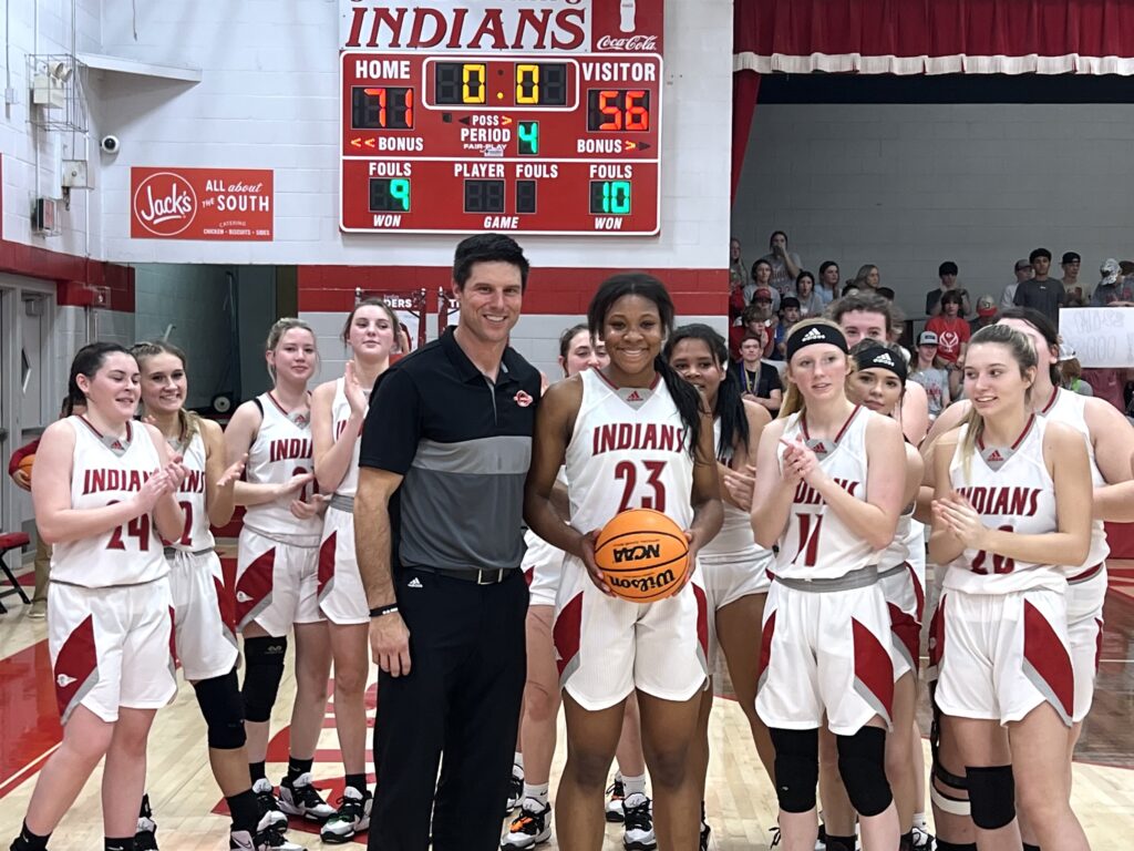 Ohatchee senior Jorda Crook (23) is surrounded by coach Bryant Ginn and her teammates on the occasion of scoring her 3,000th career point in Wednesday’s area tournament title game.