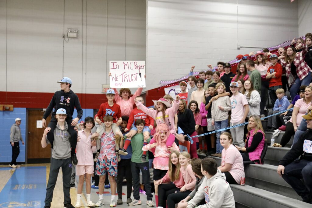 Pleasant Valley’s student section cheers the Raiders during Monday’s Northeast subregional game against Horseshoe Bend with a sign saying, ‘In MC Roper we trust.’ Macey Roper scored 35 points in the Raiders’ victory. (Photo by Krista Larkin)