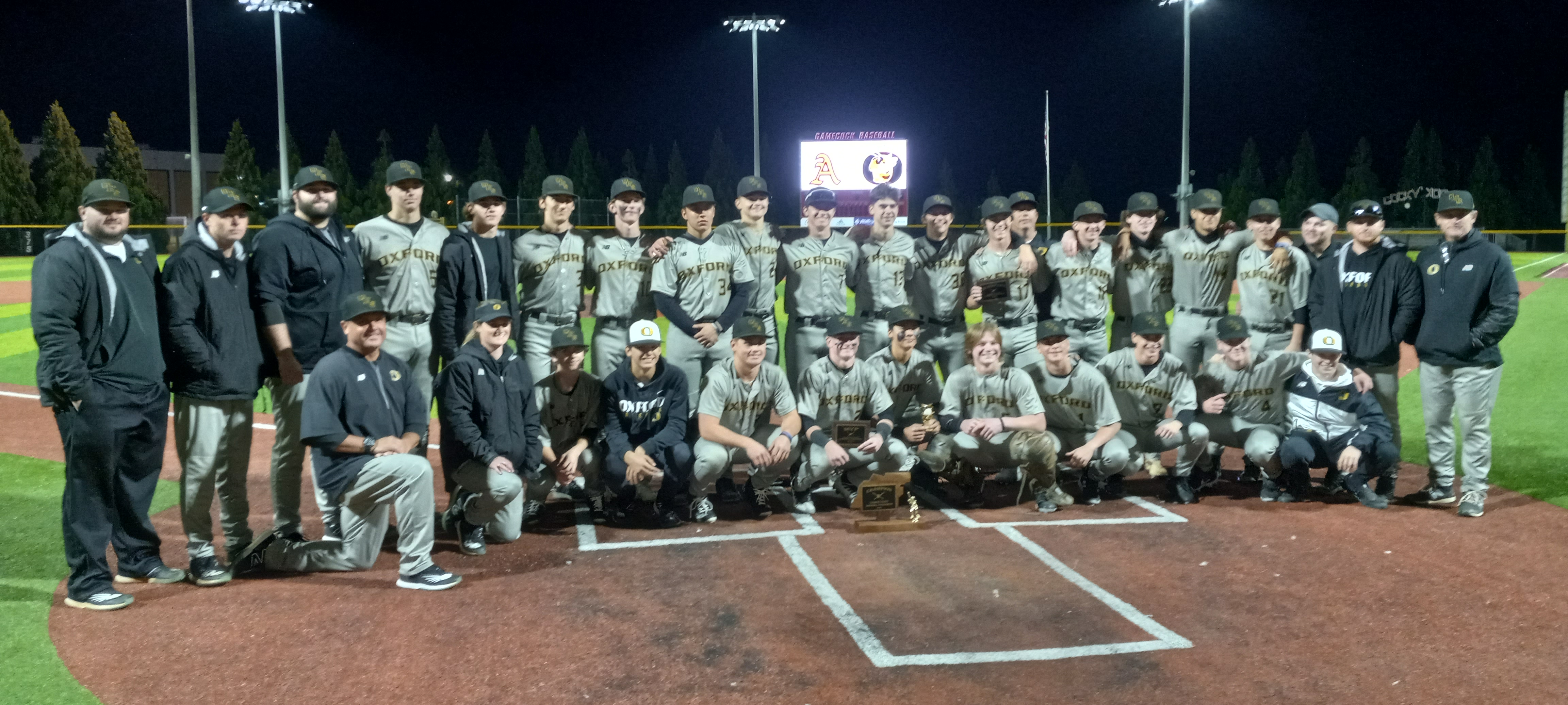 Oxford players and coaches pose with the trophy after winning the Calhoun County final Wednesday on Rudy Abbott Field. (Photo by Joe Medley)