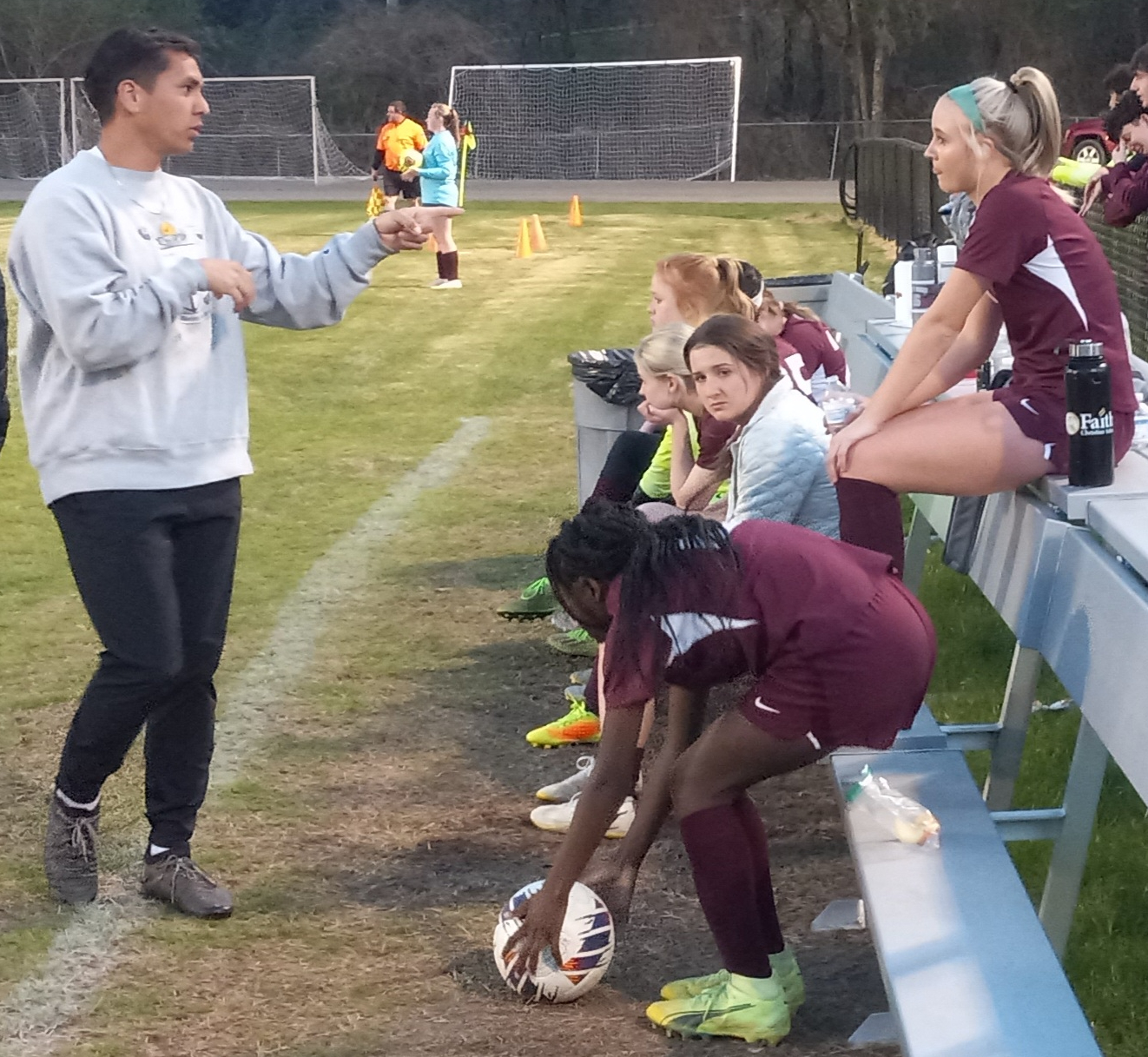 Donoho coach Vinny Yslava talks to Erin Turley in the second half of the Falcons’ victory over Weaver on Thursday. (Photo by Joe Medley)