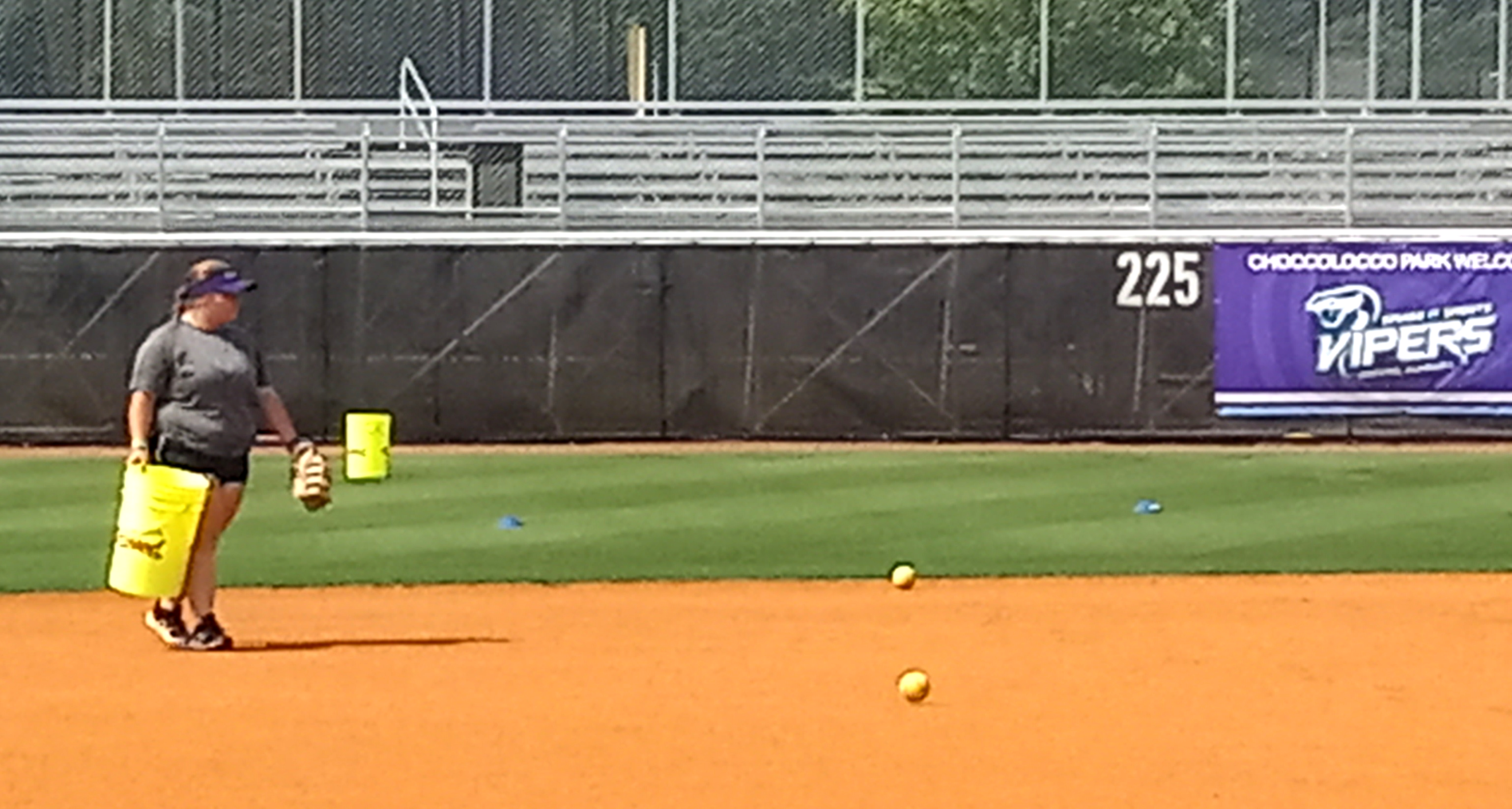 Recent Pleasant Valley High School graduate Sydney Beason, who played softball for the Raiders, picks up balls during the Smash It Sports Vipers’ practice Wednesday at Choccolocco Park. (Photo by Joe Medley)