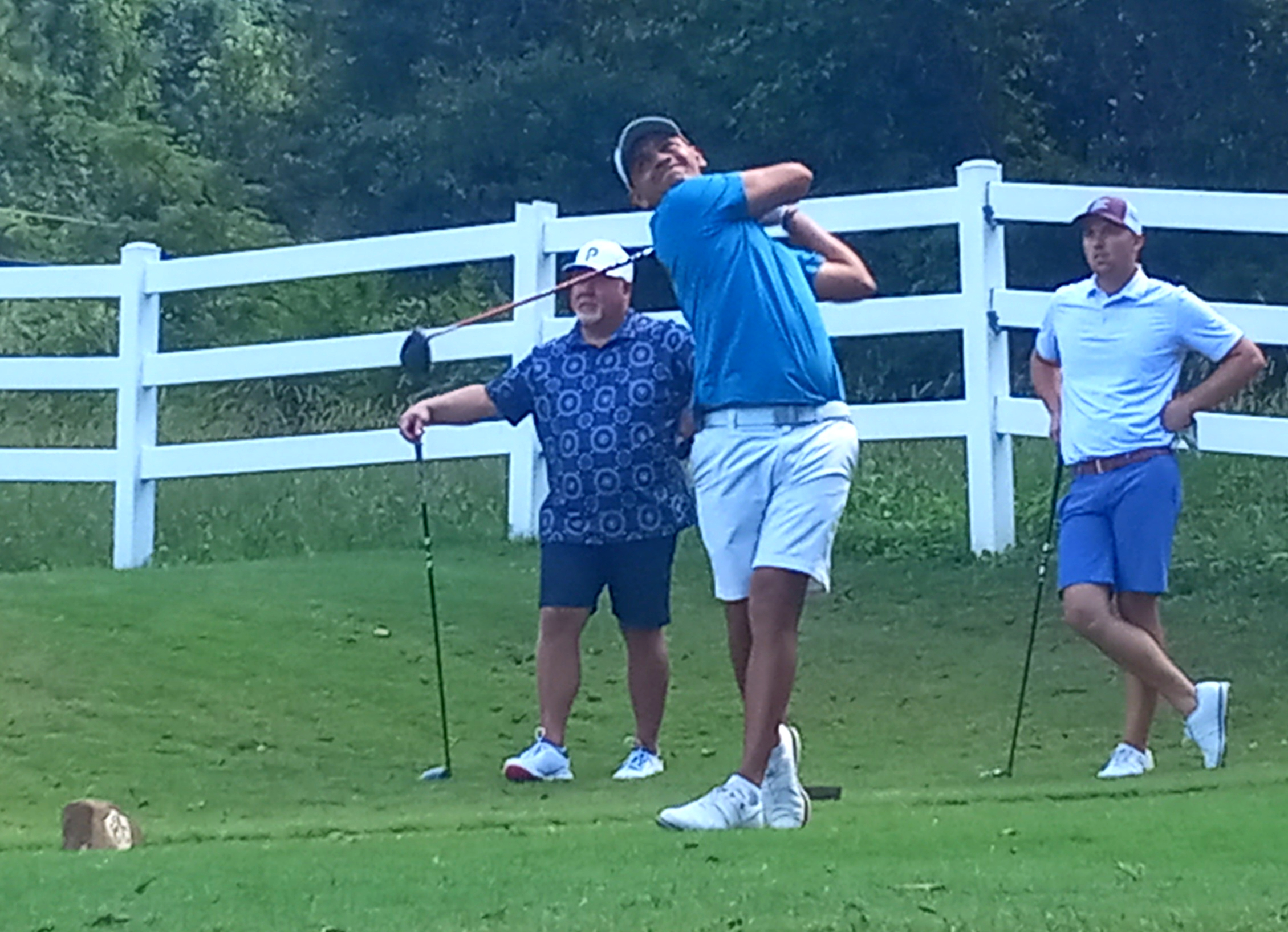 Jesus Montenegro tees off on Anniston Country Club’s No. 7 hole as teammate Layton Bussey (right) and Benji Turley watch during Sunday’s final round of the Sunny King Charity Classic. (Photo by Joe Medley/East Alabama Sports Today)