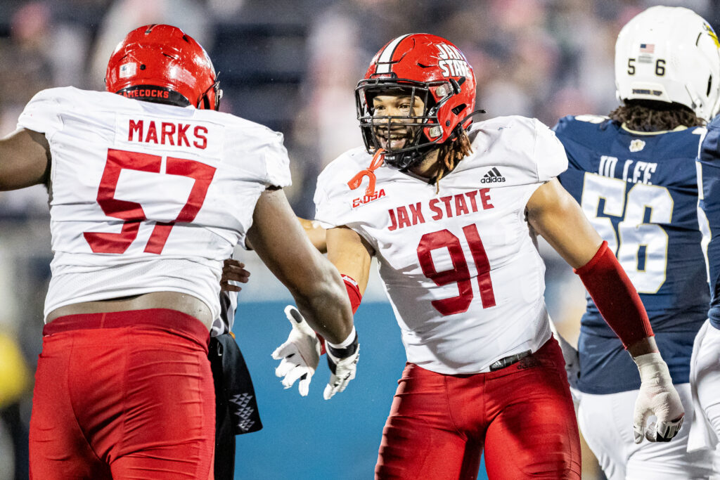 Jax State’s Chris Hardie (91) and Jeff Marks celebrate after a stop against Florida International on Wednesday in Miami. (Photo by Brandon Phillips/Jax State)