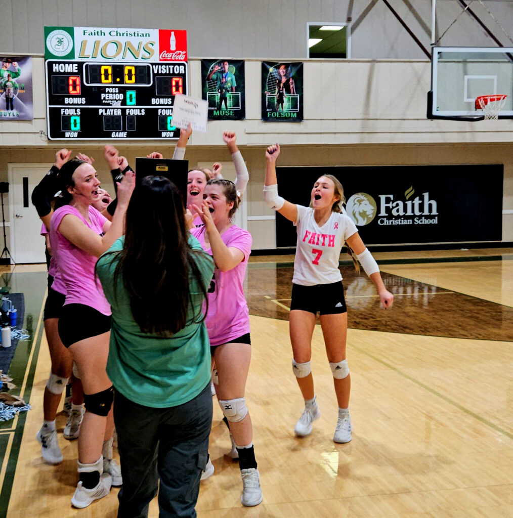 Led by MVP Ally Folsom (left) and all-tournament pick Kayson Cronan (right), Faith Christian’s volleyball team receives the Class 1A, Area 8 champion’s trophy from Faith athletics director Casey Farr on Thursday. (Photo by Joe Medley)