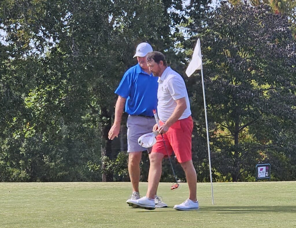 Gary Wigington and Andrew Brooks congratulate each other after finishing Sunday’s Calhoun County Match Play final at Anniston Municipal Golf Course. (Photo by Joe Medley)